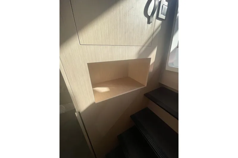 Slide: The Image of Interior of 2026 Jeanneau TH38 yacht with wooden paneling and stairs. - 26