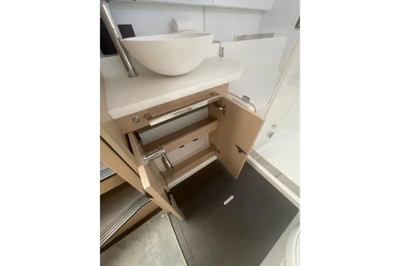 Slide: The Image of Modern bathroom interior of 2026 Jeanneau TH38 yacht with open cabinet and vessel sink. - 27