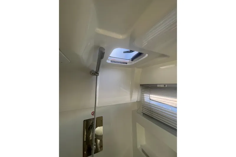 Slide: The Image of Interior of 2026 Jeanneau TH38 boat, featuring a modern shower area with a skylight. - 28