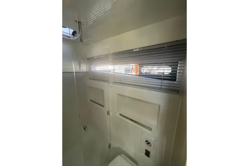 Slide: The Image of Interior of 2026 Jeanneau TH38 yacht with window blinds and sleek design. - 29