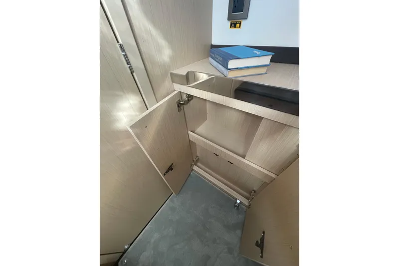 Slide: The Image of Open cabinet with books on top in Jeanneau TH38, 2026 model. - 35