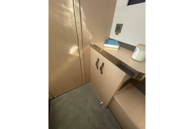 Slide: The Image of Interior of 2026 Jeanneau TH38 yacht with wooden cabinetry and books. - 36
