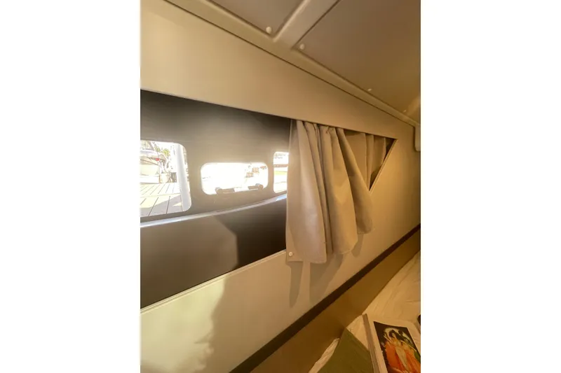 Slide: The Image of Interior view of 2026 Jeanneau TH38 yacht cabin window with curtains. - 39