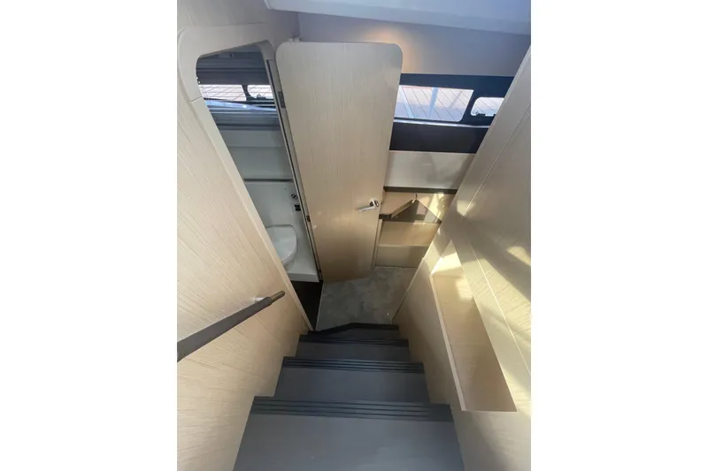 Slide: The Image of Interior stairs of 2026 Jeanneau TH38 yacht, featuring modern design and wooden finish. - 43