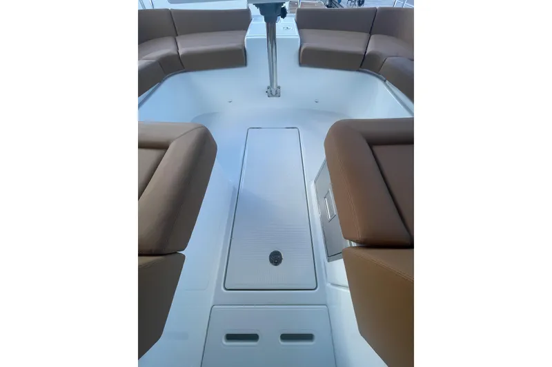 Slide: The Image of Interior view of 2026 Jeanneau TH38 boat with brown cushioned seating. - 46