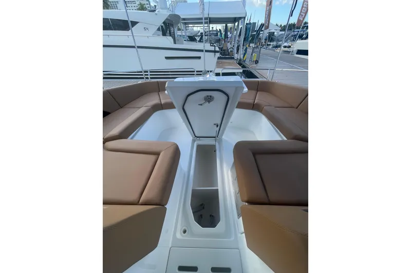 Slide: The Image of 2026 Jeanneau TH38 boat interior with open storage compartment and brown seating. - 47