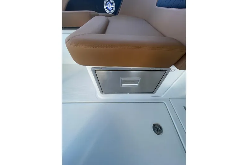 Slide: The Image of 2026 Jeanneau TH38 boat interior with brown seating and built-in storage compartment. - 48