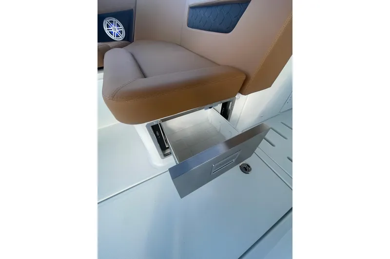 Slide: The Image of 2026 Jeanneau TH38 boat seat with integrated storage drawer open. - 49
