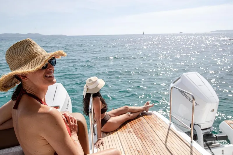 Slide: The Image of Women relaxing on a 2026 Jeanneau TH38 yacht, enjoying sunny ocean views. - 5