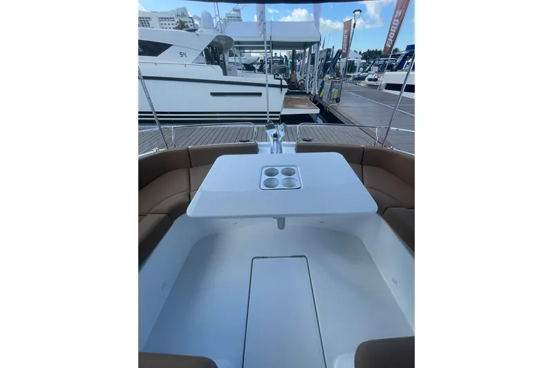 Slide: The Image of Jeanneau TH38 2026 yacht interior with seating and table at marina. - 53