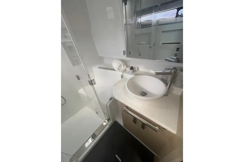 Slide: The Image of Modern bathroom in 2026 Jeanneau TH38 yacht with sleek sink and glass shower. - 60