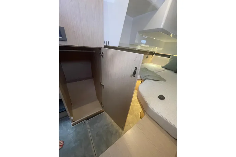 Slide: The Image of 2026 Jeanneau TH38 interior with open cabinet and cozy seating area. - 65