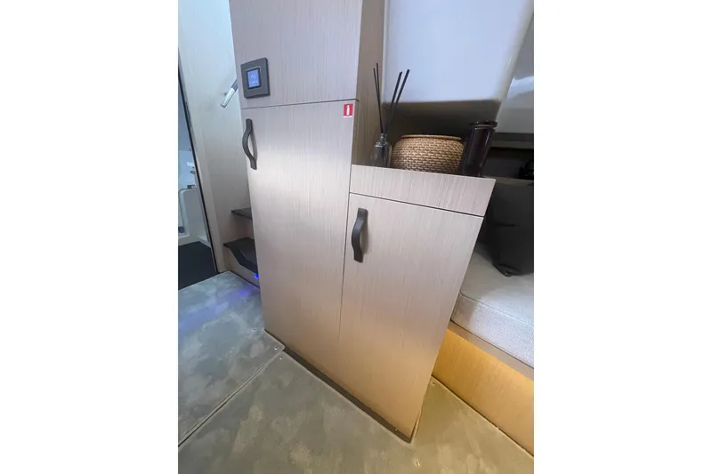 Slide: The Image of Interior of 2026 Jeanneau TH38 yacht, featuring modern cabinetry and cozy seating area. - 68