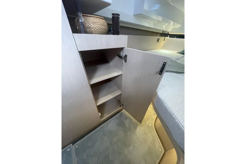 Slide: The Image of Interior of 2026 Jeanneau TH38 yacht with open wooden cabinet and cozy seating. - 69
