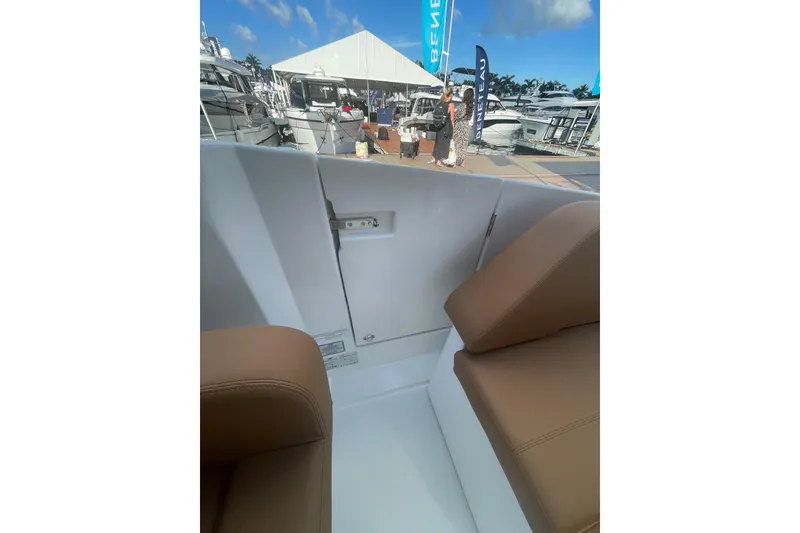 Slide: The Image of 2026 Jeanneau TH38 boat interior with brown seating at a marina event. - 71
