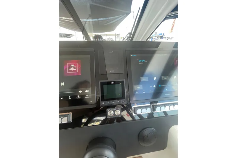 Slide: The Image of 2026 Jeanneau TH38 dashboard with modern navigation and audio controls. - 76