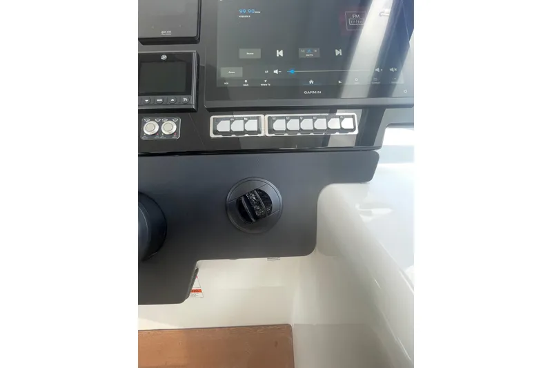 Slide: The Image of Control panel of 2026 Jeanneau TH38 boat with touchscreen and buttons. - 78