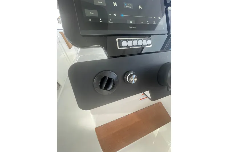 Slide: The Image of Control panel of 2026 Jeanneau TH38 boat with touchscreen and knobs. - 79