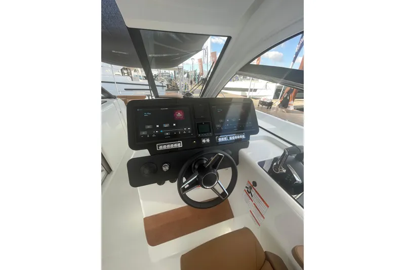 Slide: The Image of Helm of 2026 Jeanneau TH38 boat with modern controls and navigation displays. - 81