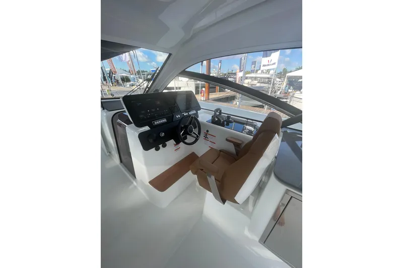 Slide: The Image of Helm of 2026 Jeanneau TH38 boat with modern controls and comfortable seating. - 82