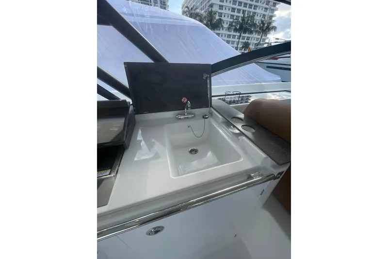 Slide: The Image of Modern Jeanneau TH38 yacht sink area, 2026 model, with sleek design and urban backdrop. - 85
