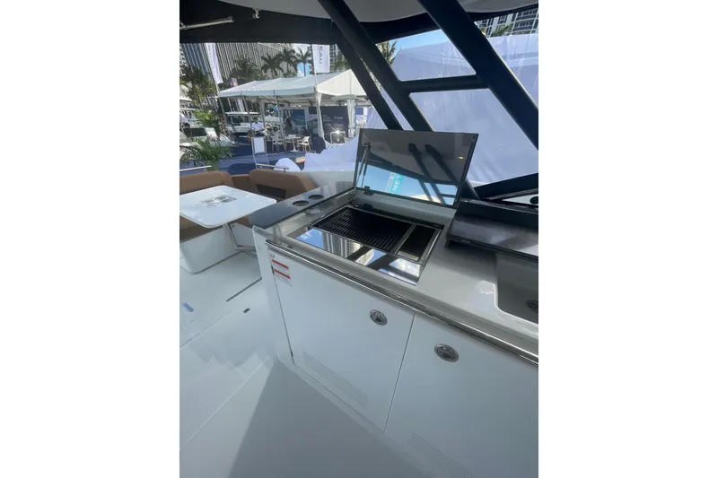 Slide: The Image of 2026 Jeanneau TH38 yacht with outdoor kitchen and seating area. - 86