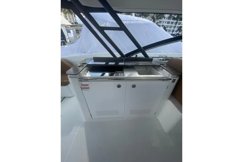 Slide: The Image of 2026 Jeanneau TH38 yacht interior with sleek kitchenette and modern design. - 87