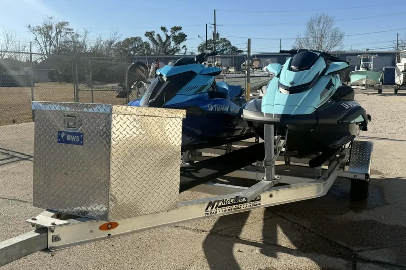 Slide: The Image of 2023 Yamaha WaveRunner GP1800R SVHO jet skis on a trailer in a sunny outdoor setting. - 11
