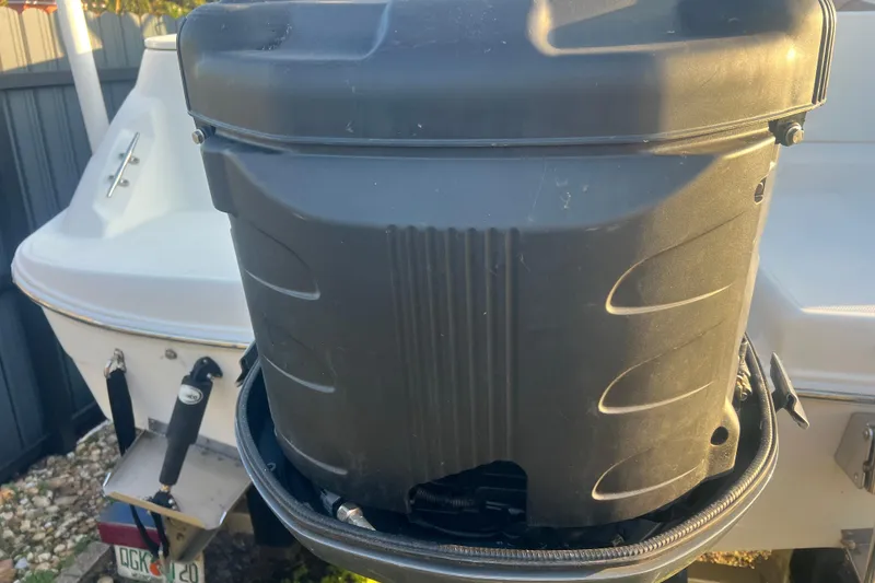 Slide: The Image of 2011 Wellcraft 232 Coastal boat with a close-up of the outboard motor. - 10