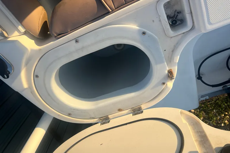 Slide: The Image of Open storage compartment on 2011 Wellcraft 232 Coastal boat, showing interior details. - 17
