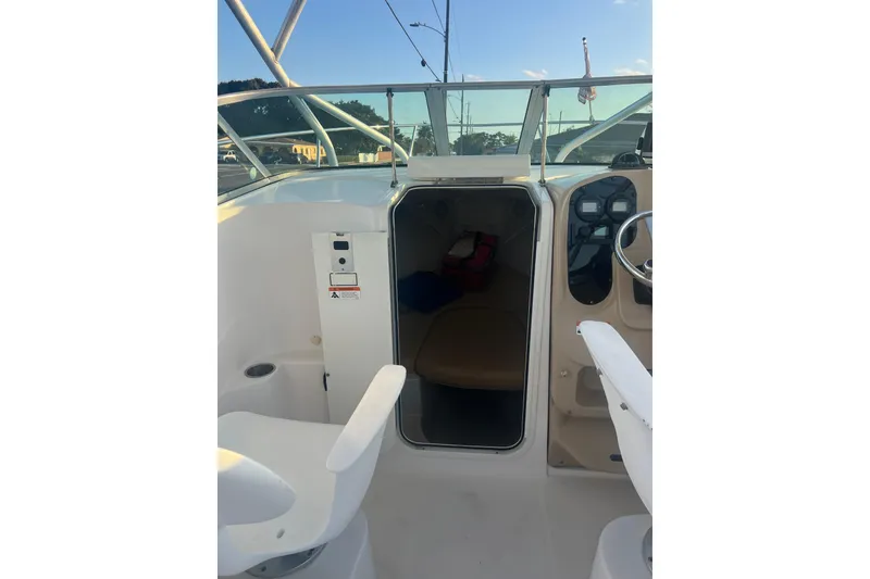 Slide: The Image of 2011 Wellcraft 232 Coastal boat interior with seating and steering wheel. - 18