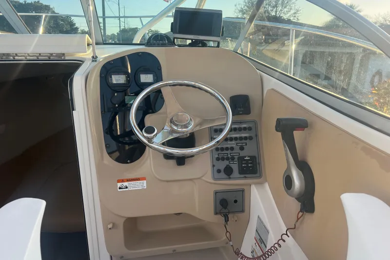 Slide: The Image of 2011 Wellcraft 232 Coastal boat helm with steering wheel and control panel. - 20