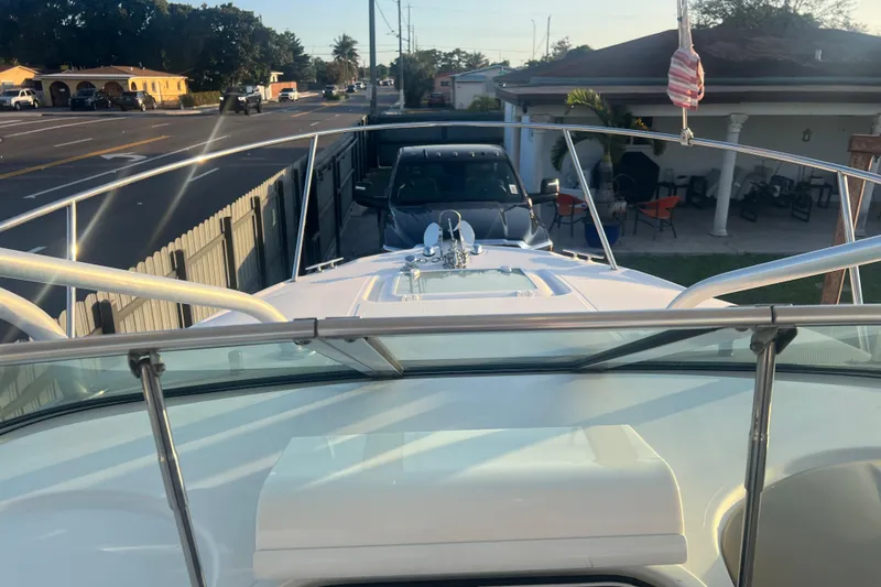 Slide: The Image of 2011 Wellcraft 232 Coastal boat parked in a residential driveway, sunny day. - 23