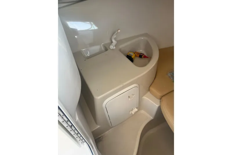 Slide: The Image of Interior of 2011 Wellcraft 232 Coastal boat with sink and storage compartment. - 26