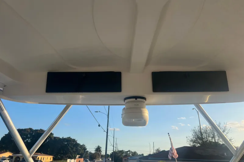 Slide: The Image of 2011 Wellcraft 232 Coastal boat interior roof with mounted equipment and clear sky view. - 27