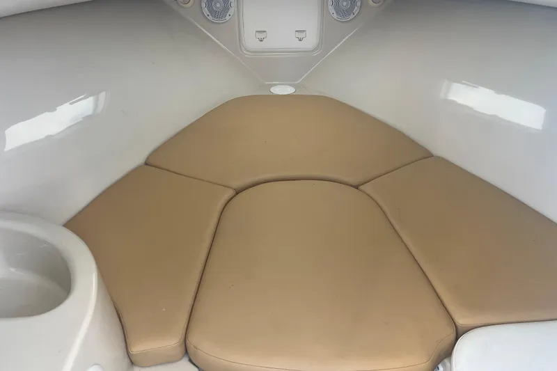 Slide: The Image of 2011 Wellcraft 232 Coastal cabin interior with beige cushions and white walls. - 28