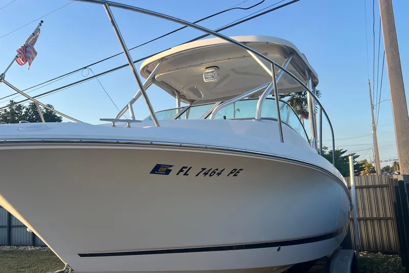 Slide: The Image of 2011 Wellcraft 232 Coastal boat with registration FL 7464 PE, docked outdoors. - 3