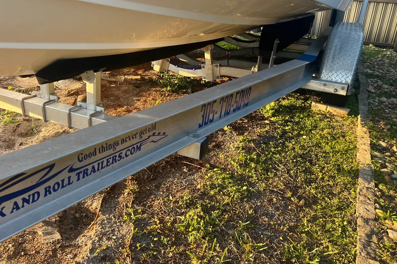 Slide: The Image of 2011 Wellcraft 232 Coastal boat on a trailer, parked on grass. - 33