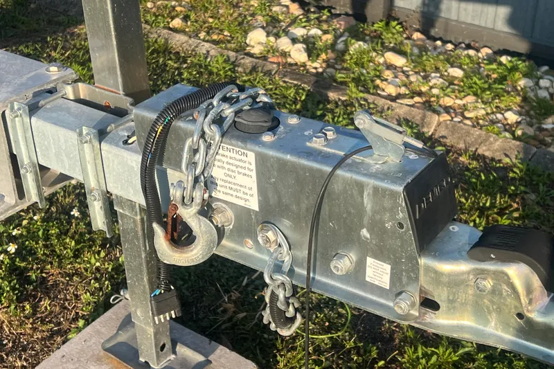 Slide: The Image of Trailer hitch with safety chains and brake actuator for 2011 Wellcraft 232 Coastal boat. - 35