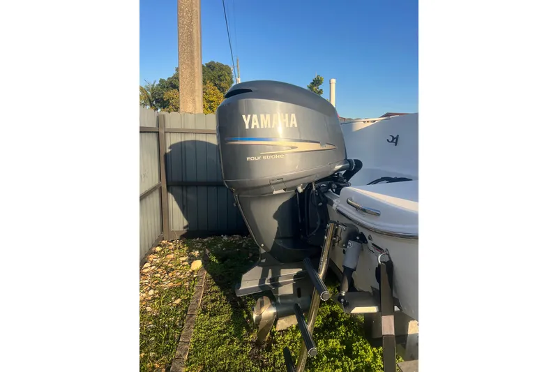 Slide: The Image of 2011 Wellcraft 232 Coastal boat with Yamaha four-stroke outboard motor in a yard. - 8