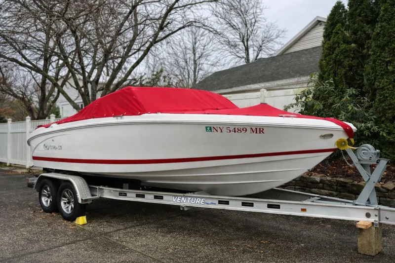 The Image of 2020 Cobalt 200S boat with red cover on trailer. - 0