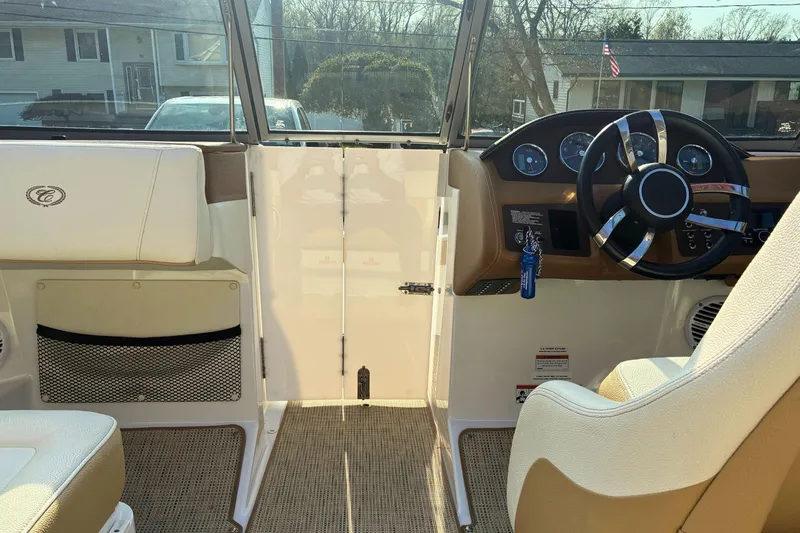 Slide: The Image of Interior view of a 2020 Cobalt 200S boat cockpit with steering wheel and seating. - 13