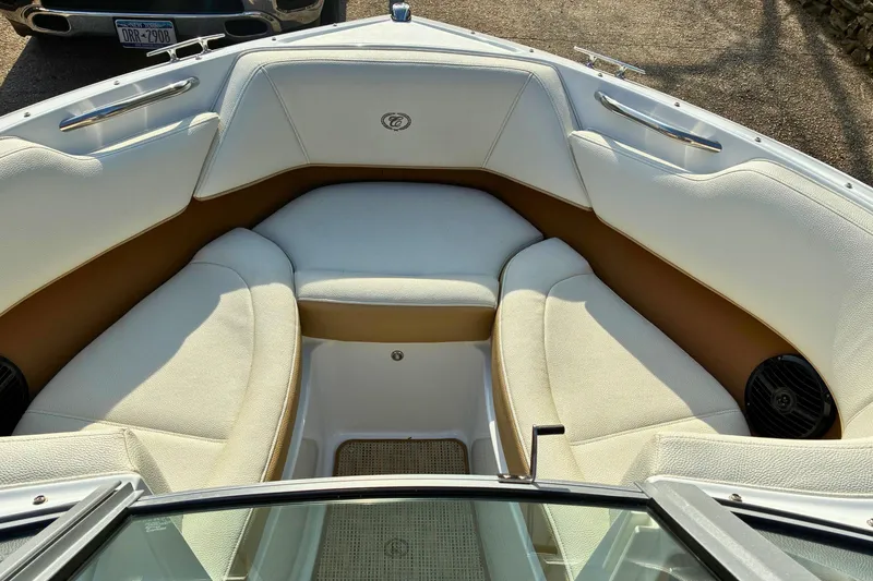 Slide: The Image of 2020 Cobalt 200S boat interior with white and tan seating, featuring stainless steel accents. - 17