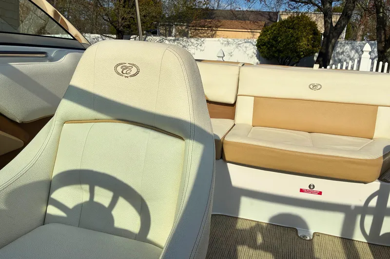 Slide: The Image of 2020 Cobalt 200S boat interior with beige and tan seating, featuring embroidered logos. - 18