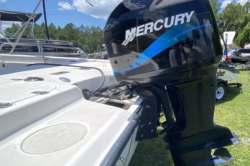 Slide: The Image of Boston Whaler 220 Dauntless 2004 with Mercury outboard motor in a grassy area. - 11
