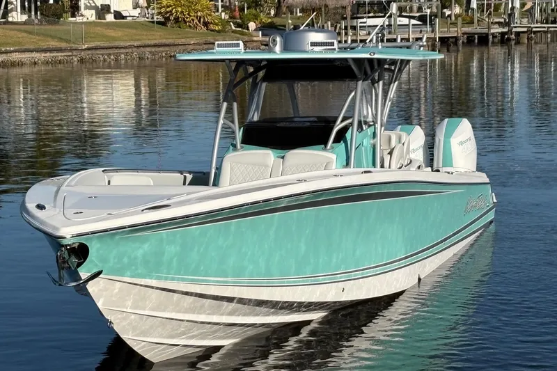 Slide: The Image of 2024 Nor-Tech 390 Sport Center Console boat on calm water, showcasing sleek design. - 10