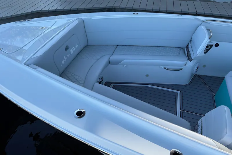 Slide: The Image of 2024 Nor-Tech 390 Sport Center Console boat interior with white seating and sleek design. - 15