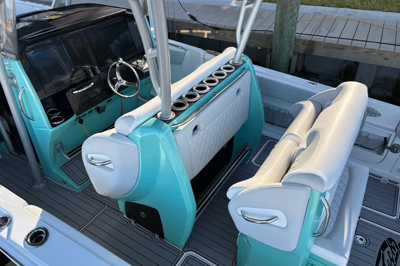 Slide: The Image of 2024 Nor-Tech 390 Sport Center Console interior with turquoise accents and modern seating. - 17