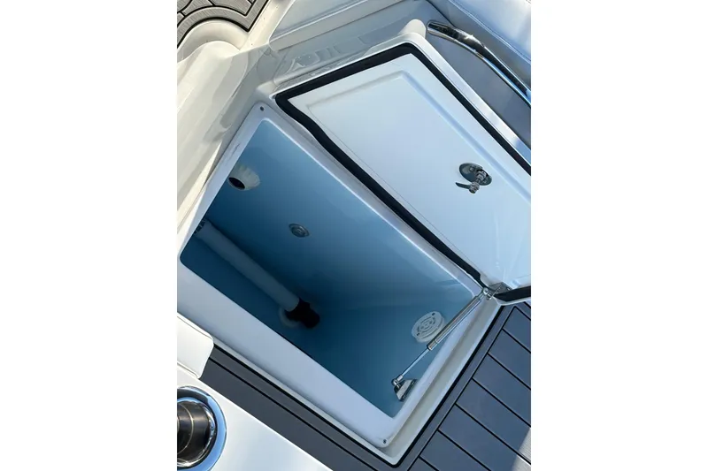 Slide: The Image of Open storage compartment on 2024 Nor-Tech 390 Sport Center Console boat. - 24