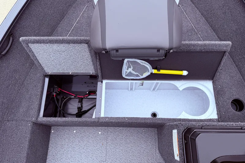 Slide: The Image of 2026 Lund 1650 Rebel XL SS boat interior with storage compartments and fishing net. - 10